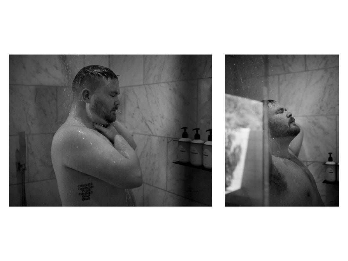 Spread 18 of 18 from Twin Palms: two photographs of a bearded man showering, water running over his face and shoulders; black and white.