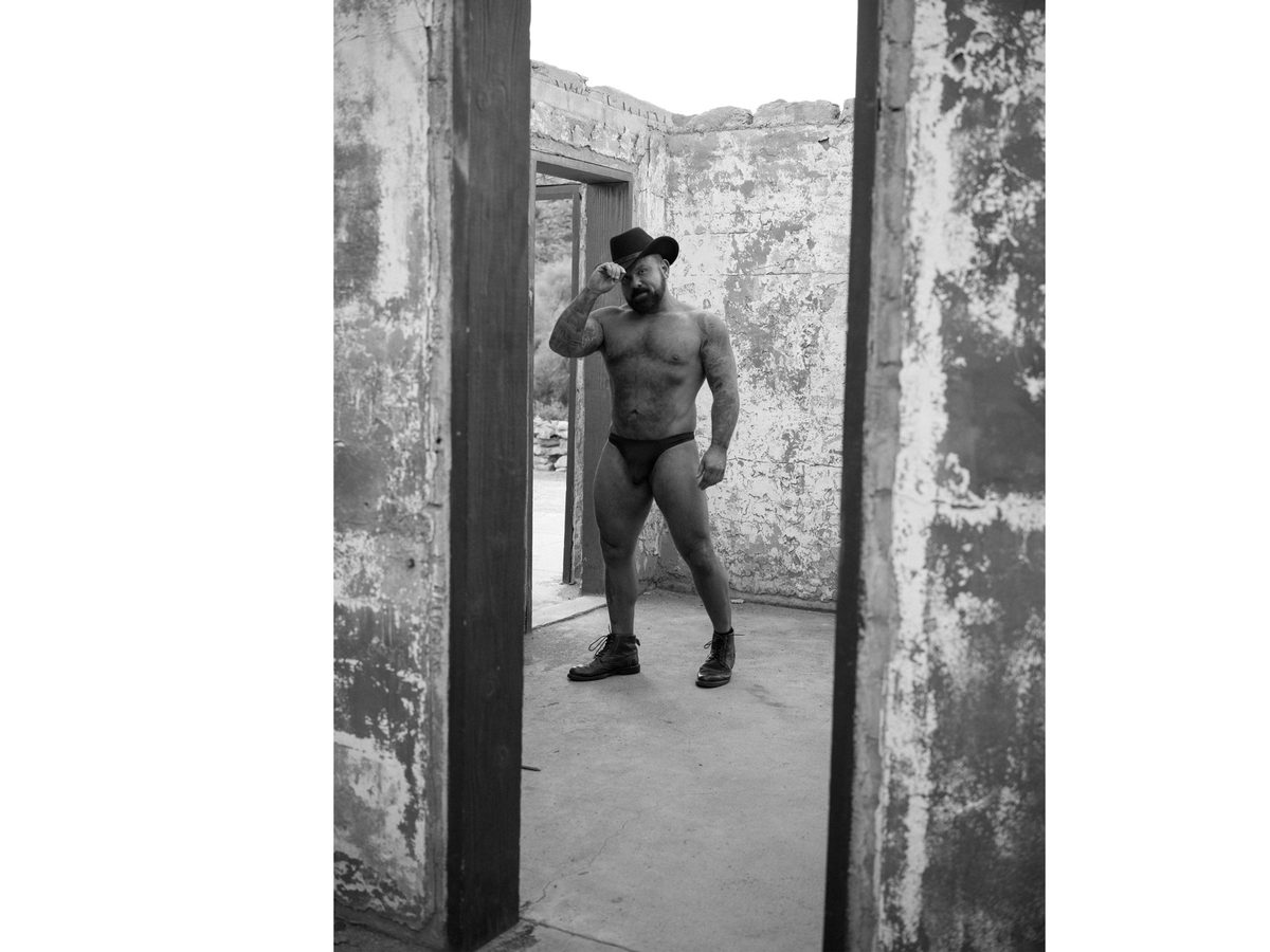 Spread 3 of 6 from Scorpion Gultch, AZ: a bearded man in a cowboy hat and briefs stands in a ruined doorway; black and white.