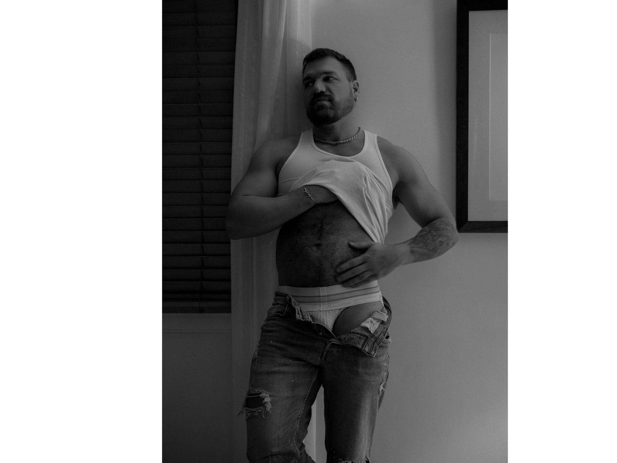 Spread 3 of 10 from Chateau Marmont: a bearded man in a tank top and jockstrap leans against a wall, jeans at his thighs; black and white.